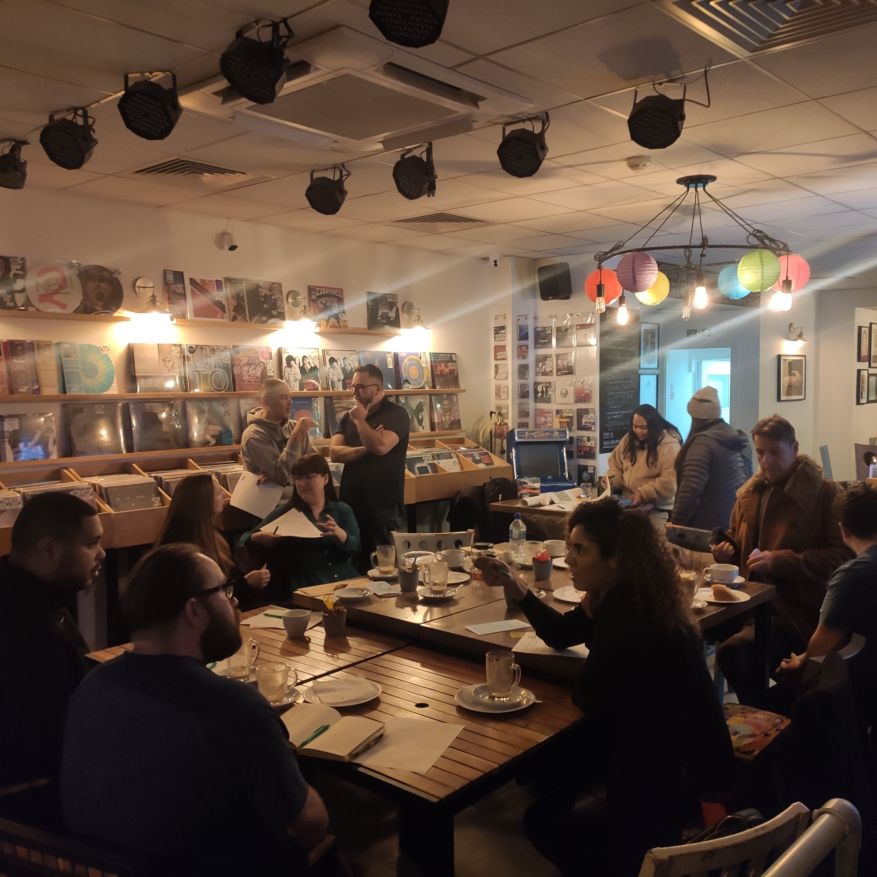 image of people enthusiastically talking and networking at a previous event at Wax and Beans cafe in Bury town centre